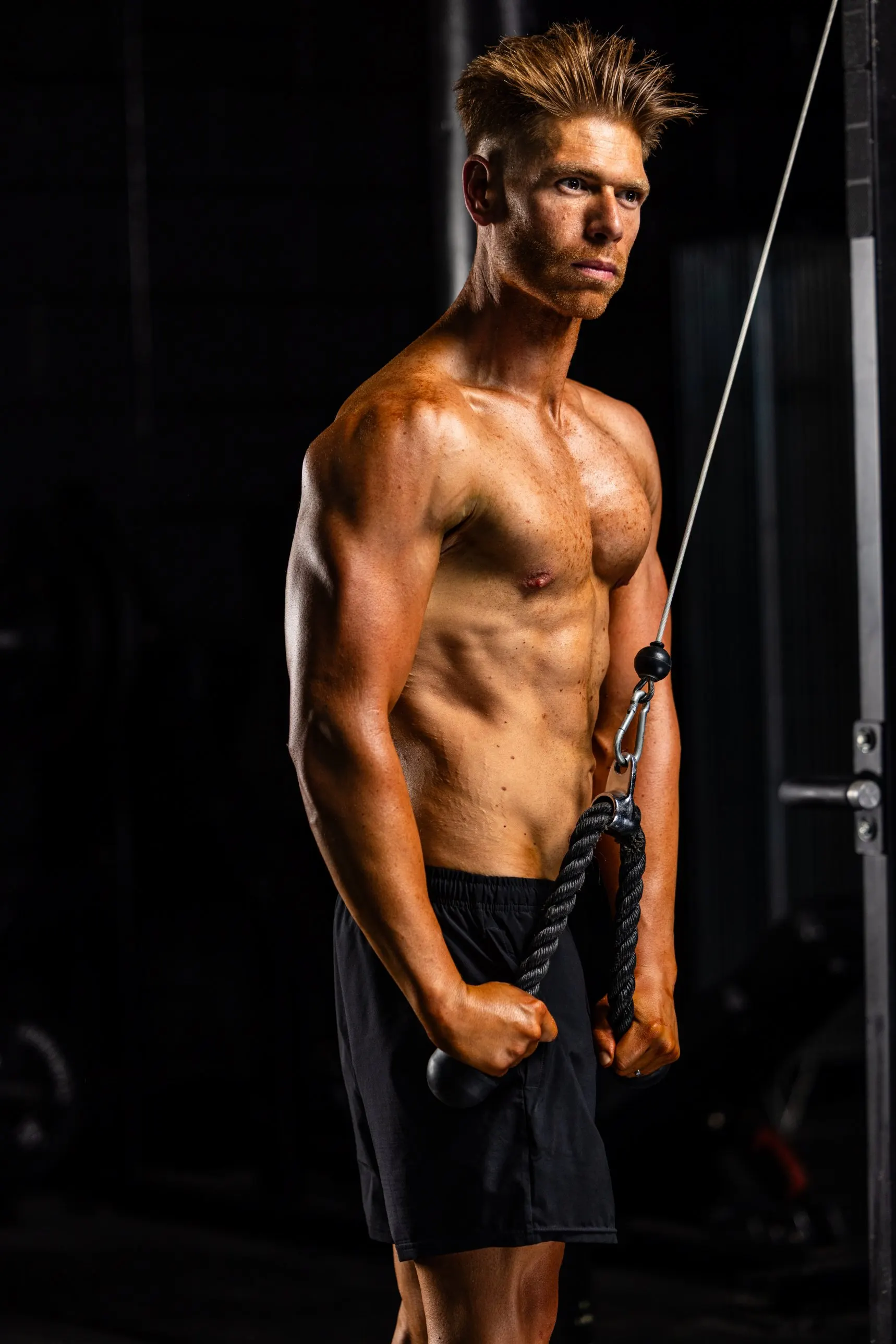 Tom Edwards training on a cable machine at his 2026 photoshoot